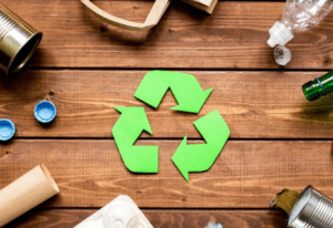 a green recycle symbol surrounded by garbage